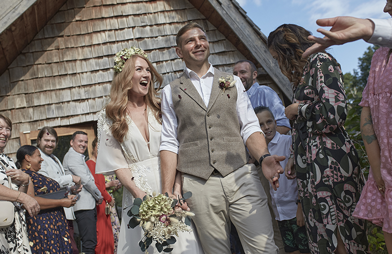 The happy couple exit the cermony to be congratulated by their family and friends